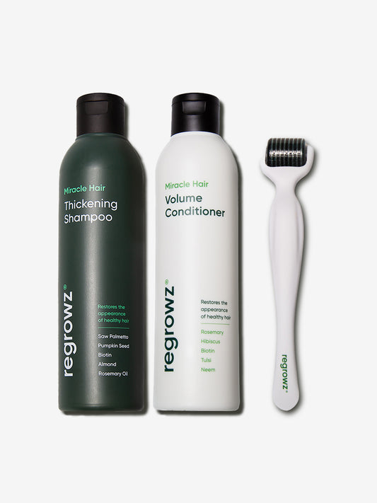Regrowz  Complete Miracle Hair Kit with two product bottles and a scalp dermaroller arranged on a plain white background.